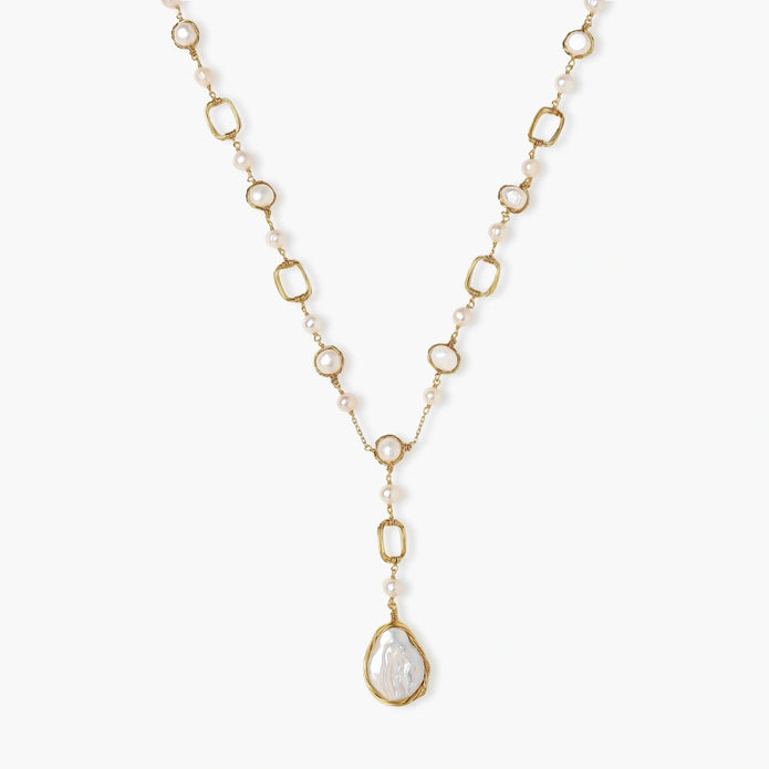 Long gold-plated necklace with alternating freshwater pearls and crystal bezels, featuring a large baroque pearl pendant