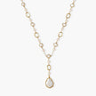 Long gold-plated necklace with alternating freshwater pearls and crystal bezels, featuring a large baroque pearl pendant