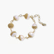 Adjustable bracelet with baroque pearls wrapped in delicate gold mesh netting connected by textured chain links